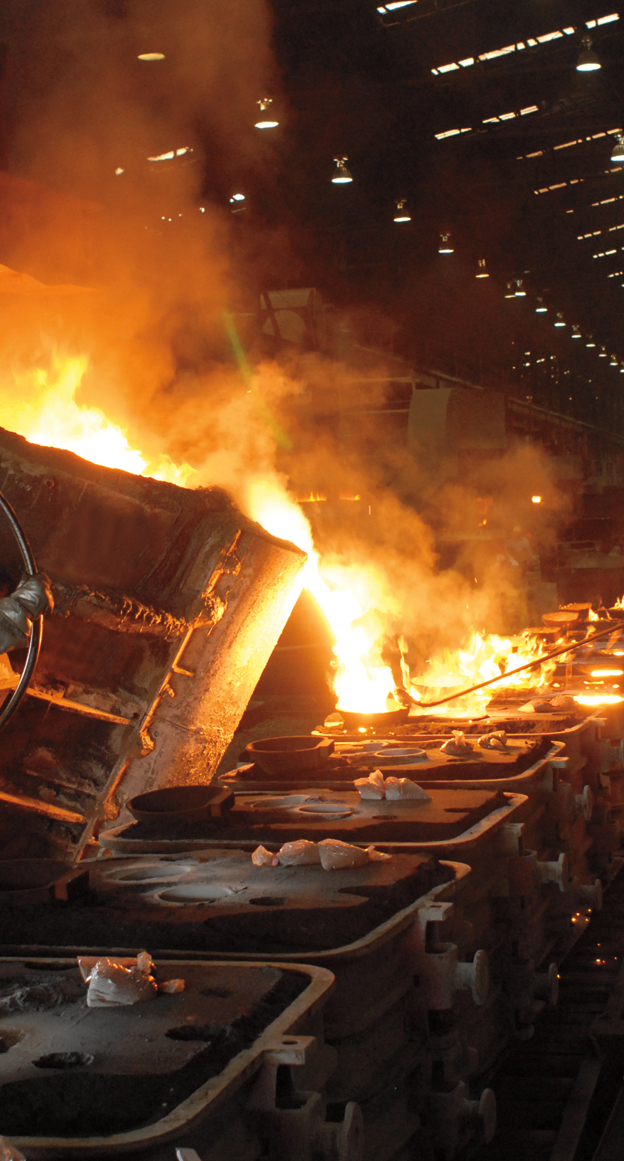 Molten steel being poured into a mold to make a mining wear part.